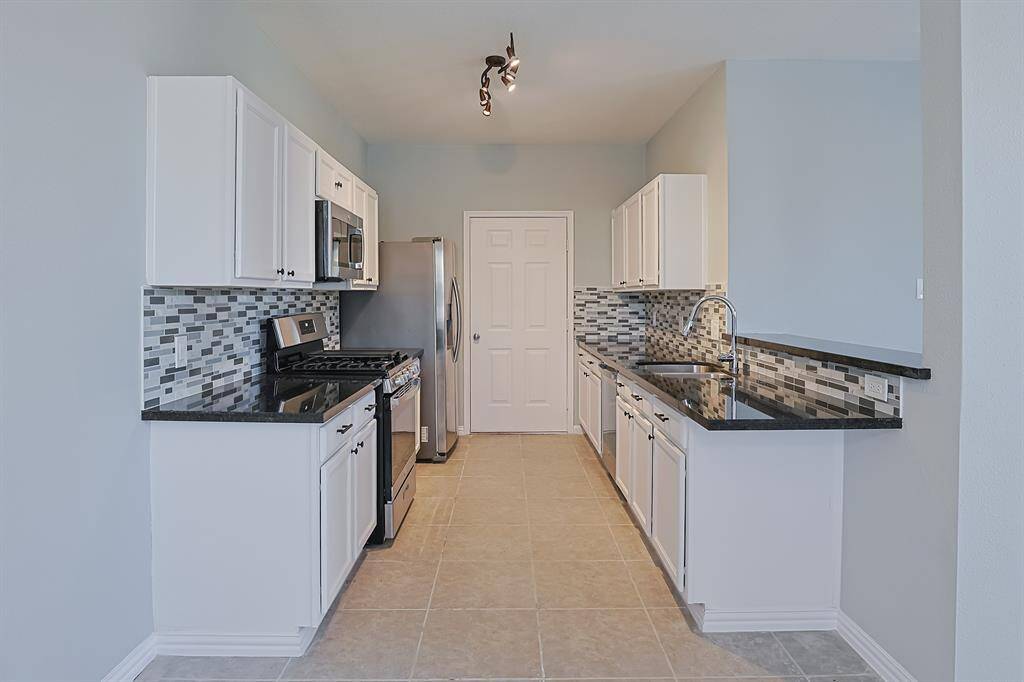 The modern kitchen is featuring brand-new appliances, sleek countertops, and contemporary cabinetry.
