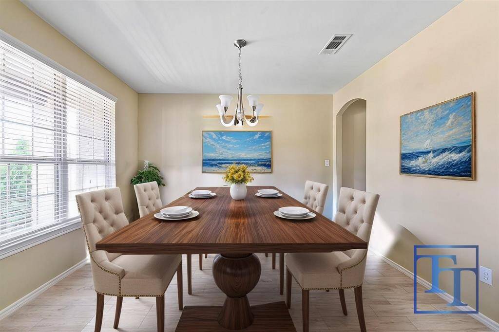 The formal dining area is basked in natural light and is ready to host the next family gathering.