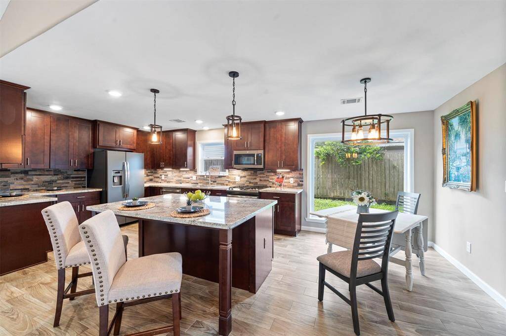 The kitchen comes equipped with a large center island, creating tons of counter space, and ample cabinet/storage space to match.