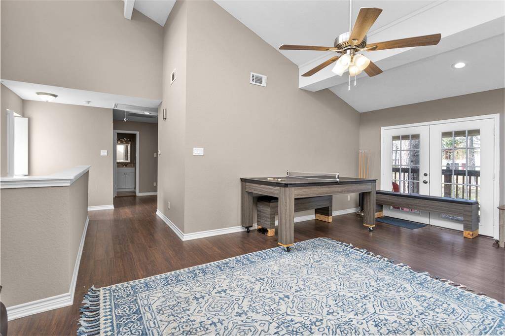 French doors lead to the balcony overlooking the backyard oasis and Lake Conroe!