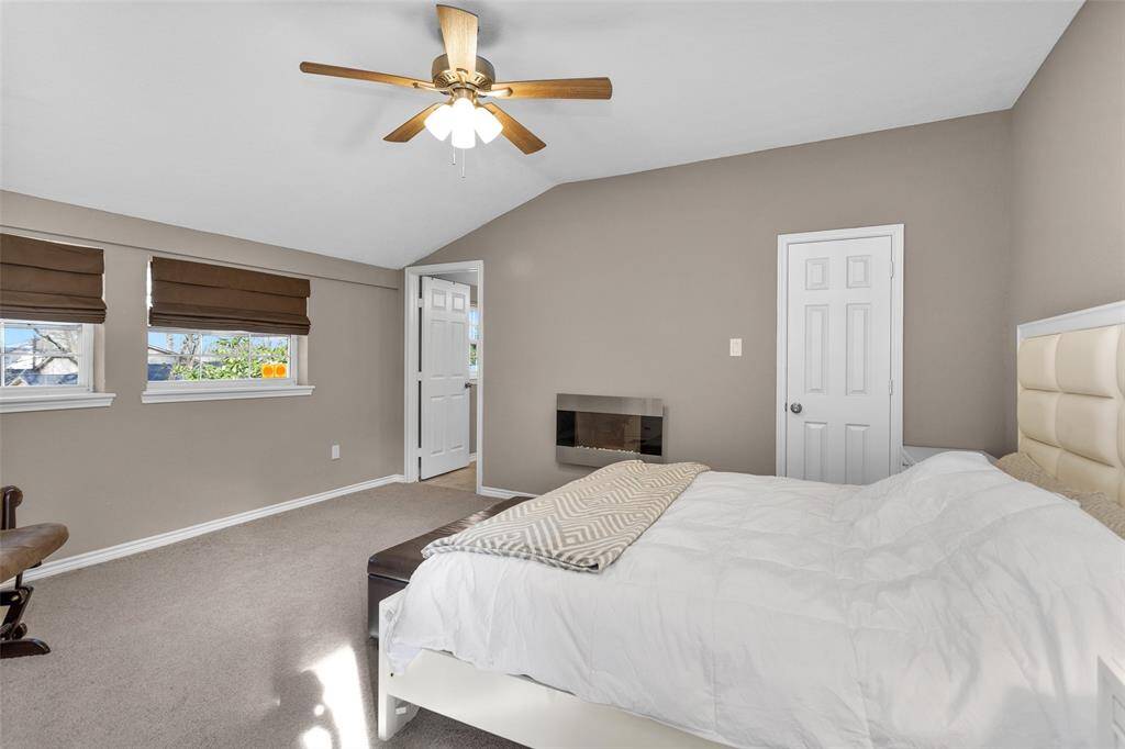 Primary bedroom upstairs overlooks the backyard oasis and Lake Conroe.