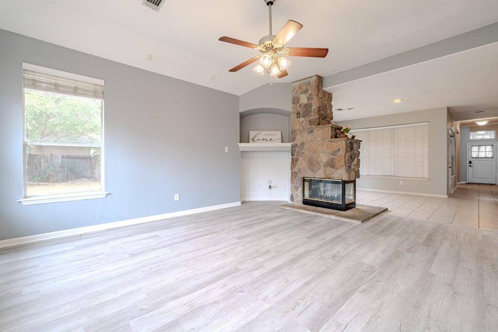 Just off the kitchen is another dining room/ sitting room that shares a pass through gas fireplace with the spacious living room.