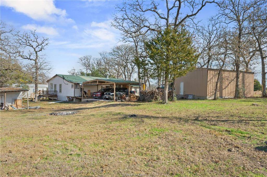 View of yard with an outbuilding and a carport