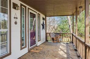 Large front porch with a porch swing great place to sit and relax