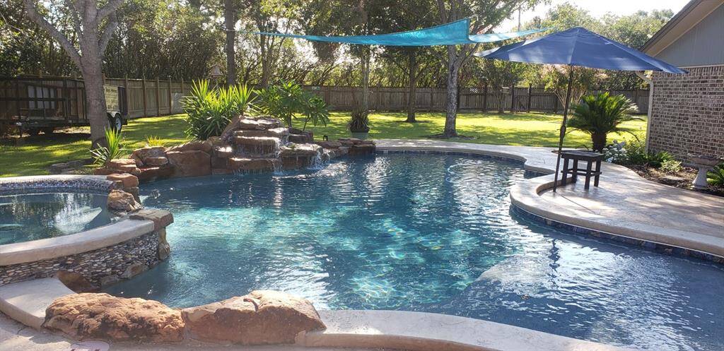 Swimming Pool with Hot Tub and abundant decking.