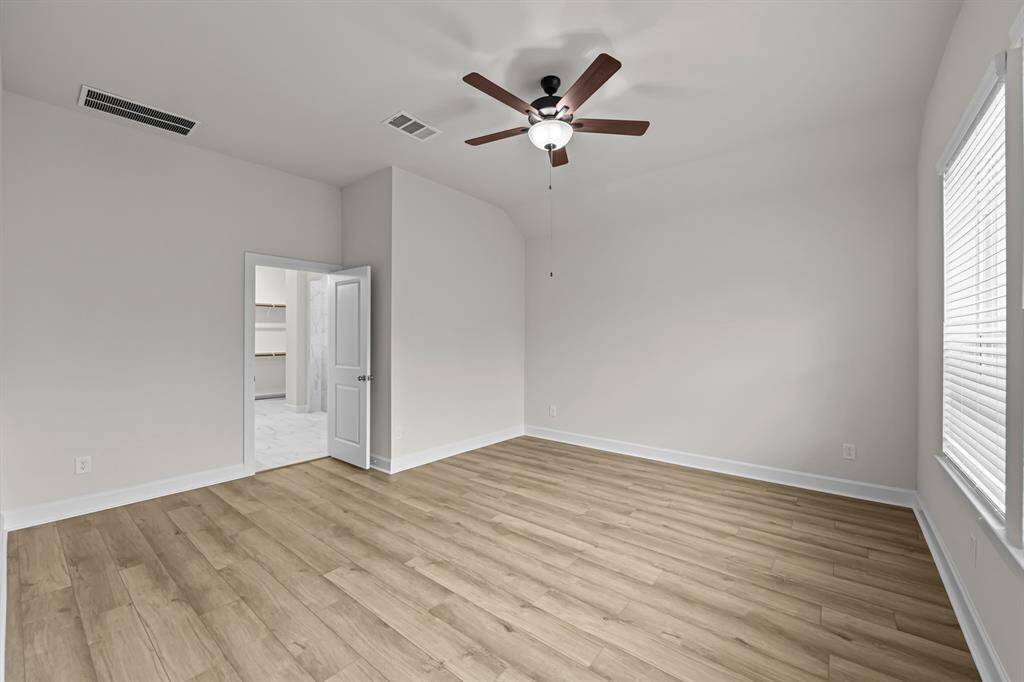 Big windows and high ceilings and vinyl plank floors at Master suite.
