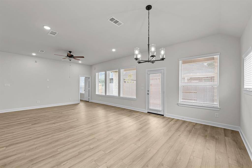 Spacious Living area with 10 ft ceilings, vinyl plank floors and set up to hang a TV on the wall!