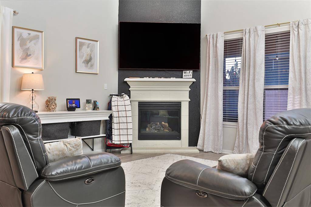 Embrace warmth and comfort by cozying up next to the fireplace.