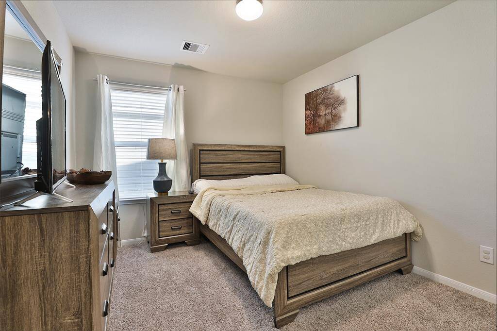 Another secondary bedroom filled with natural light.