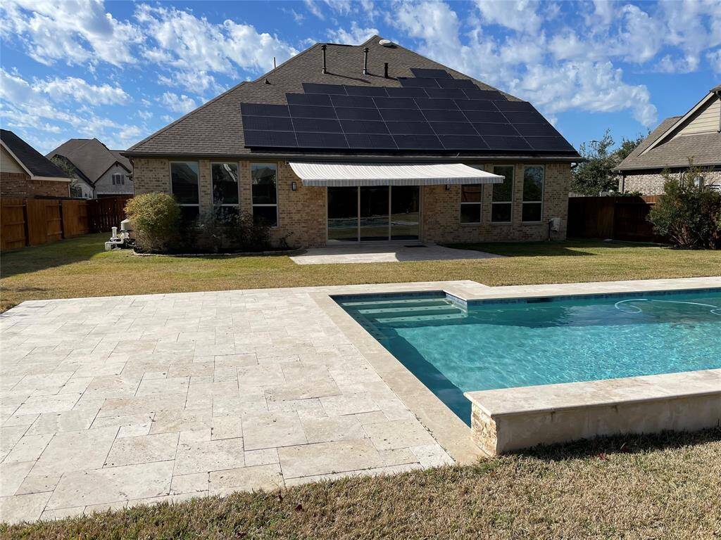 Enjoy extended shade in the patio area that flows seamlessly from the dining room through its wide sliding doors.