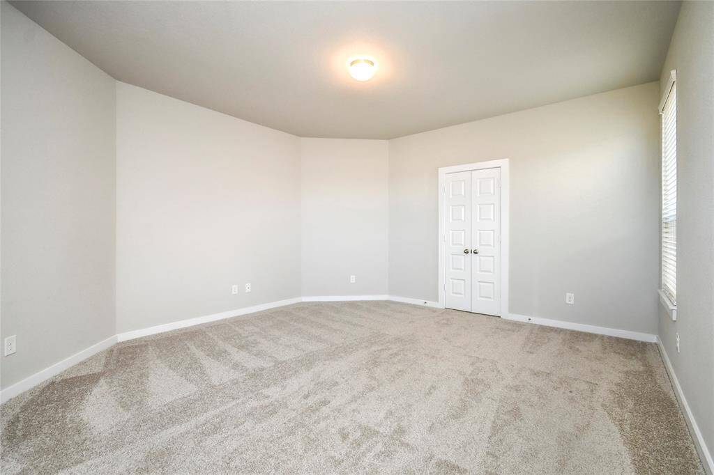 Come and unwind after a long day in this magnificent primary suite! This spacious room features plush carpet, warm paint, high ceilings and large windows with privacy blinds. Sample photo of completed home with similar floor plan. Actual colors and selections may vary.