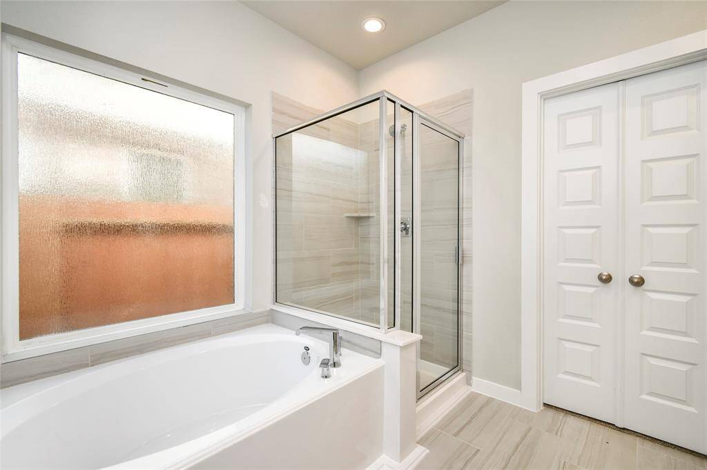 Escape to a spa-like oasis in this primary bathroom. Sample photo of completed home with similar floor plan. Actual colors and selections may vary.