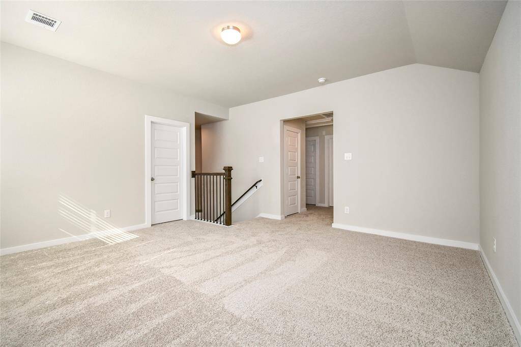 Come upstairs and relish a day of relaxation in this loft area! Ideal as an additional living space or game room, it boasts plush carpeting, high ceilings, custom paint, and windows that flood the area with abundant natural light. Sample photo of completed home with similar floor plan. Actual colors and selections may vary.