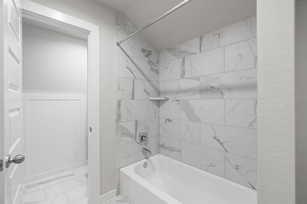 Bath/shower combo in this jack and jill bathroom. Sample photo of completed home with similar floor plan. As-built interior colors and selections may vary. Sample photo of completed home with similar floor plan. Actual colors and selections may vary.
