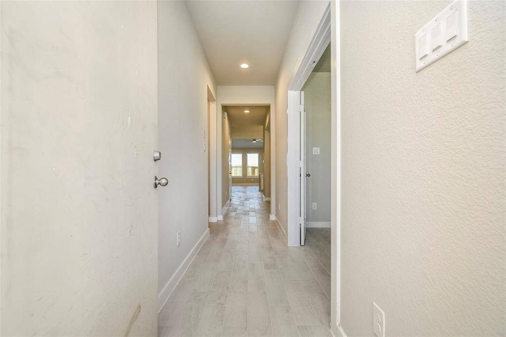 As you step into the threshold of this luxurious home, you'll soon be welcomed by anelegant glass door (to be installed). Inside, soaring ceilings amplify the spaciousness,while the refined wood-look tile flooring and oversized baseboards exudesophistication and charm. Sample photo of completed home with similar floor plan. Actual colors and selections may vary.