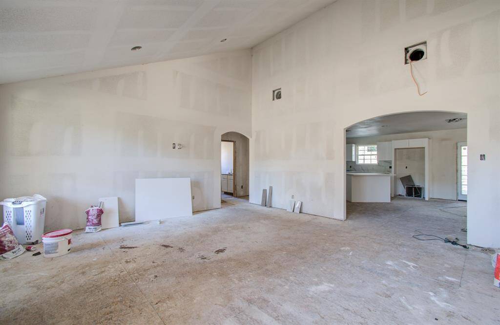 The living room is a versatile space with abundant natural light, perfect for relaxing, entertaining, or customizing to suit your needs.