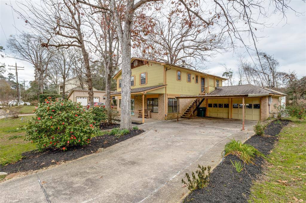Large driveway with carport and attached garage