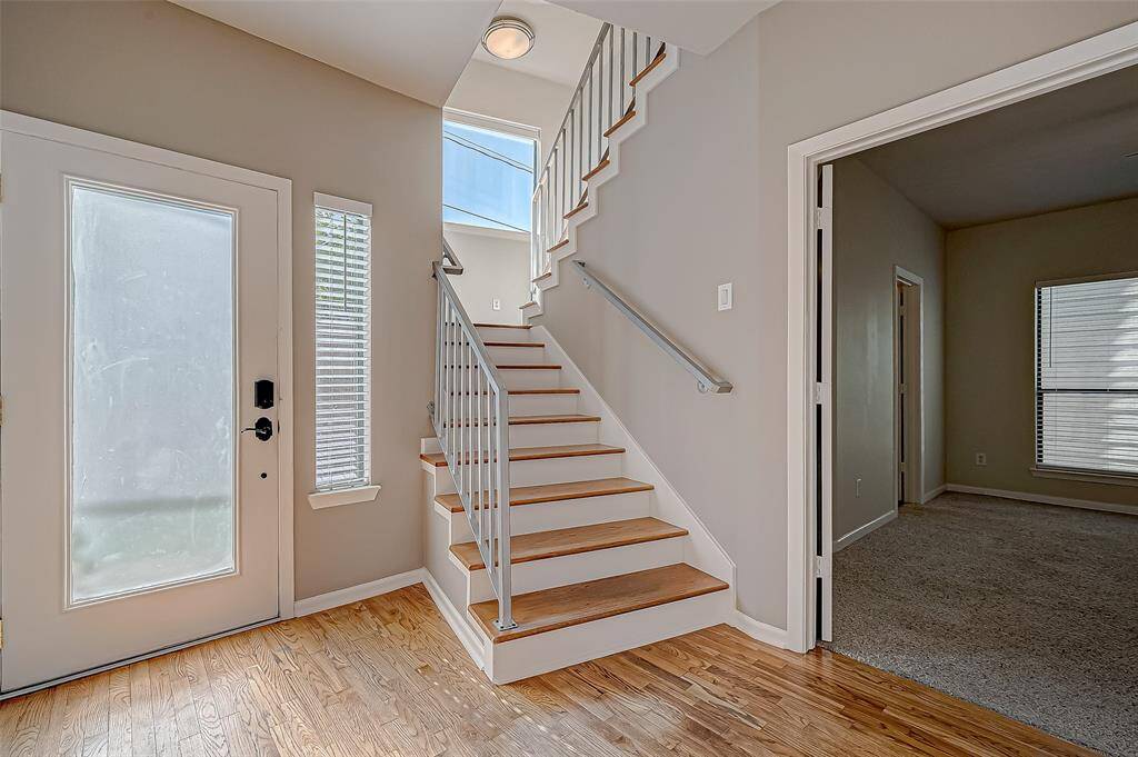 FIRST FLOOR ENTRY AREA LEADING TO BEDROOM 3 AND STAIRWAY TO UPPER FLOORS
