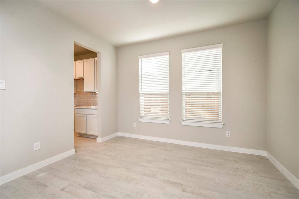 Craft enduring memories with loved ones around the table! This roomy dining area boasts stylish flooring, personalized paint, and is conveniently situated next to the family room and kitchen. Sample photo of completed home with similar floor plan. Actual colors and selections may vary.