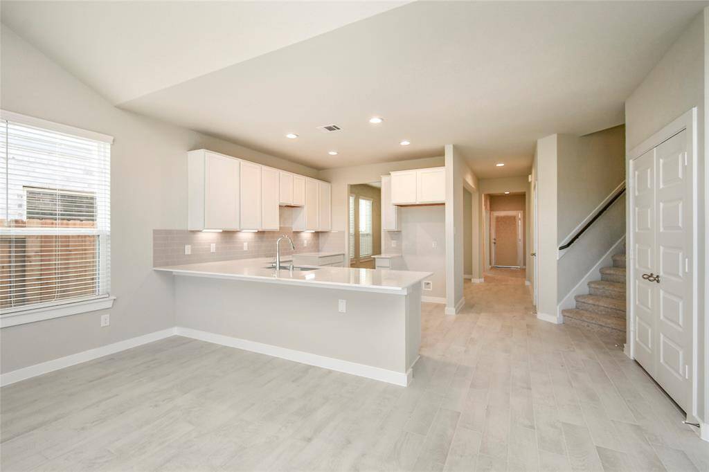 All of this overlooks your expansive family room, creating a perfect space forculinary delights and family gatherings. Sample photo of completed home with similar floor plan. Actual colors and selections may vary.
