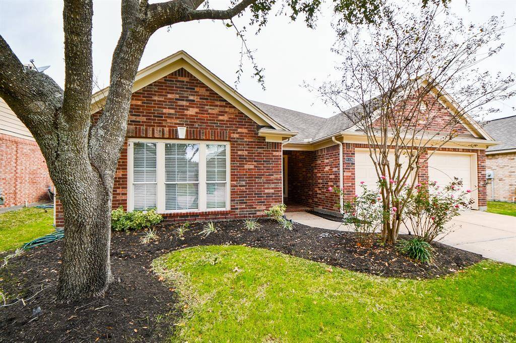 Charming Perry home with 1.5 stories, featuring a beautiful brick exterior and a welcoming front garden. Perfect for comfortable living.