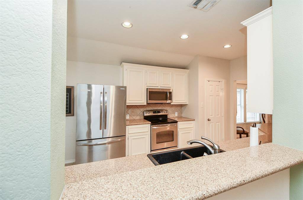 Cozy breakfast bar with modern appliances and ample counter space for casual dining.