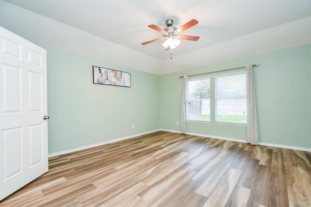 Spacious premier bedroom with new LVP flooring, perfect for a king-size bed, dressers, or a cozy sitting area.