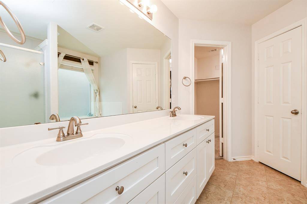 Luxurious bathroom featuring a separate shower and an expansive walk-in closet.