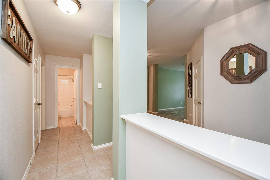 A private hallway connects to three bedrooms and a secondary bath.
