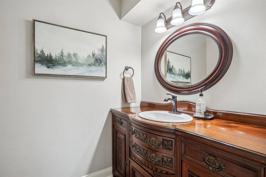 Charming powder room featuring a unique custom vanity crafted from a vintage buffet.