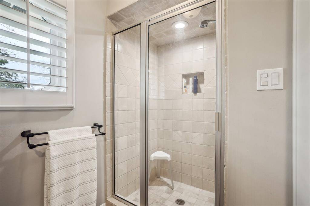 Spacious walk-in shower in the primary suite, offering comfort and elegance.