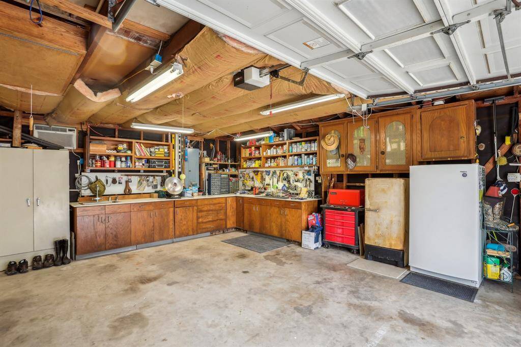 Spacious garage with ample storage and workspace, perfect for projects and vehicle parking.