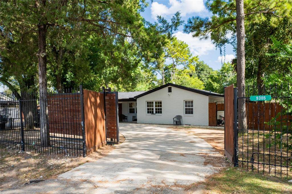 Street view of the property with gate access.