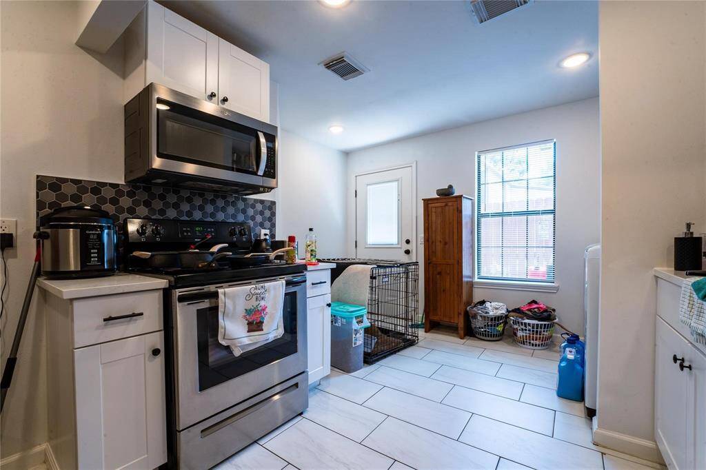 Unit 1 - kitchen and laundry area for full-sized washer/dryer