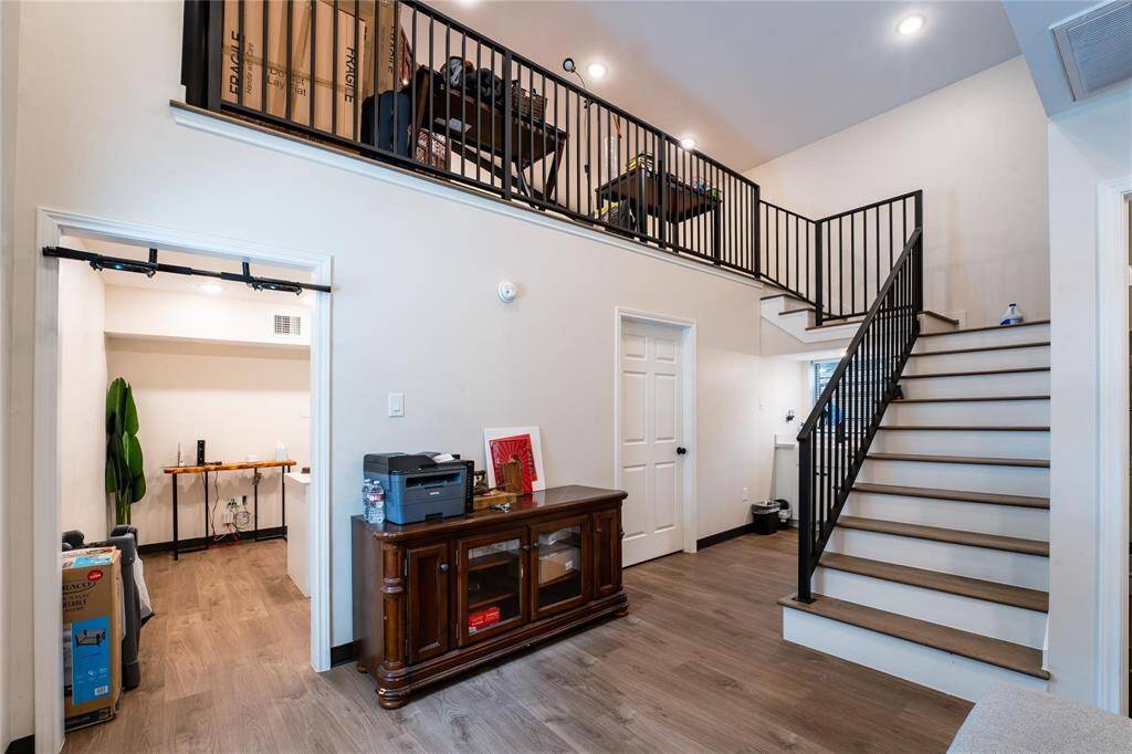 Office - living area with stairs leading to a loft