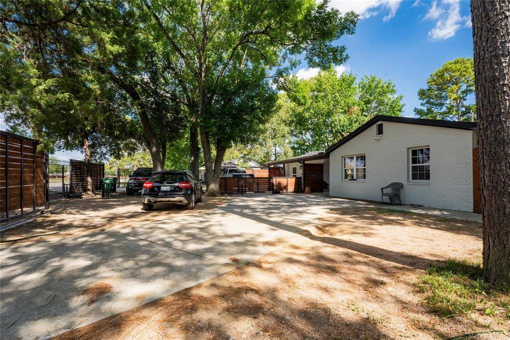 Front of the property from driveway with a pedestrian passthrough gate between Unit 1 and Unit 2.