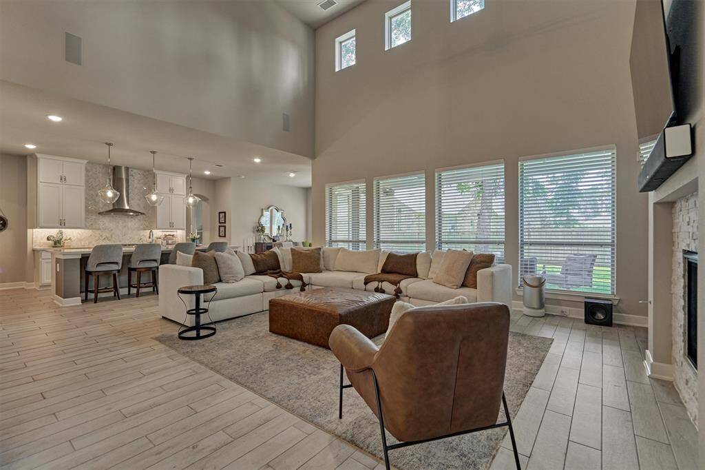 The Family Room Is Also Adjacent To The Kitchen Which Allows The Host To Remain Part Of The Conversation When Entertaining. Even With A Large Covered Patio, The Upper Windows Ensure A Good Amount Of Natural Light Flows Into The Space.