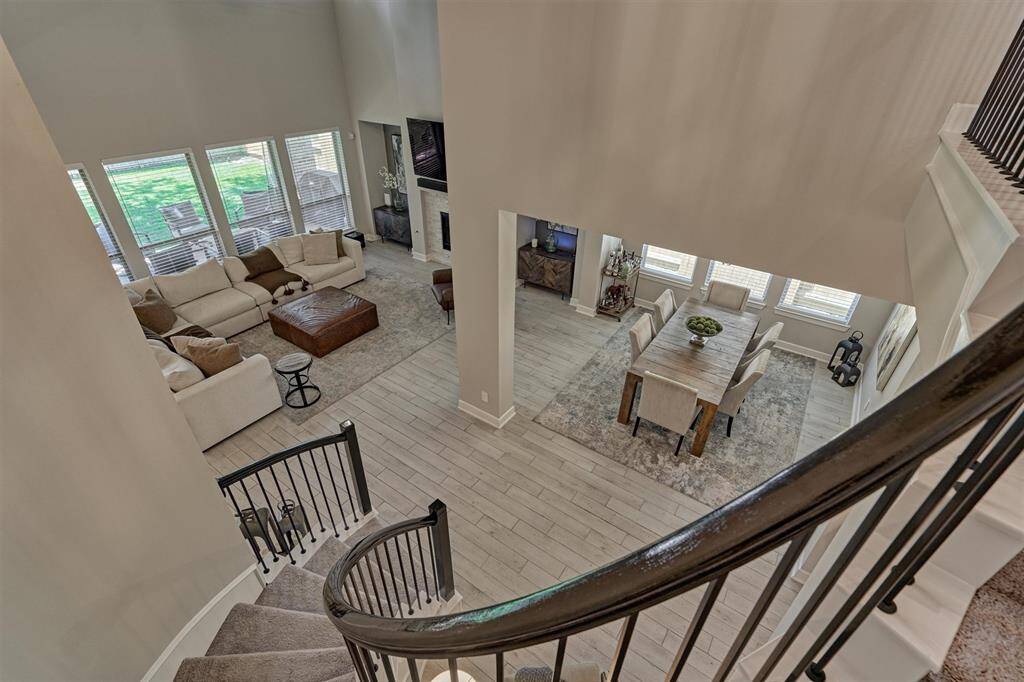 An Impressive View From The Top Of The Stairway Down Into The Family Room And Dining Room.
