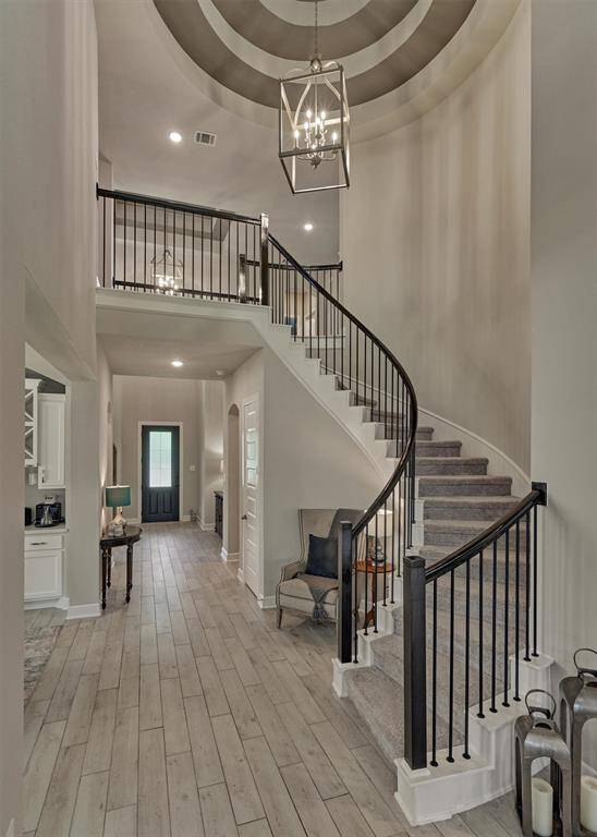 A Dramatic Spiral Stairway And Rotunda Lead To The Rooms Upstairs.  Note The Accent Paint In The Rotunda Ceiling And An Attractive Chandelier.