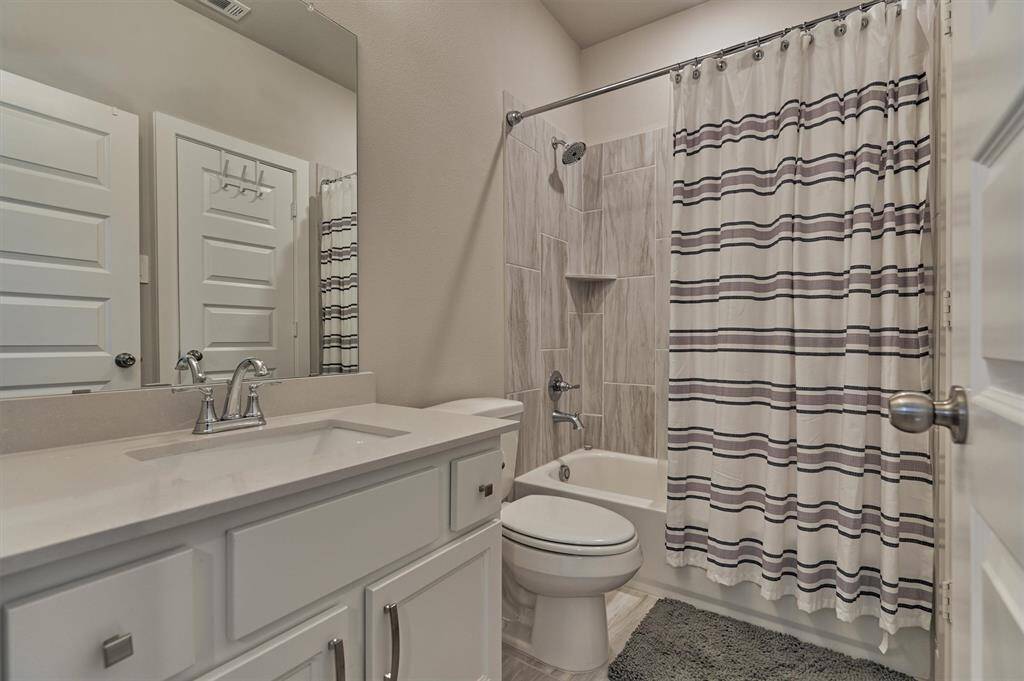 The Secondary En Suite Bath Features Quartz Counters, Under-Mount Sink, Walk-In Closet, And Tub/Shower Combination.