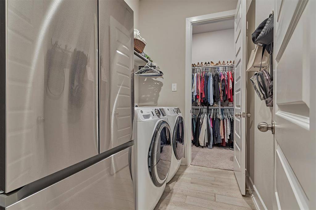 The Laundry Room Is Conveniently Accessed Through One Of The Primary Suite Closets And From The Hallway Containing The Garage Entrance.