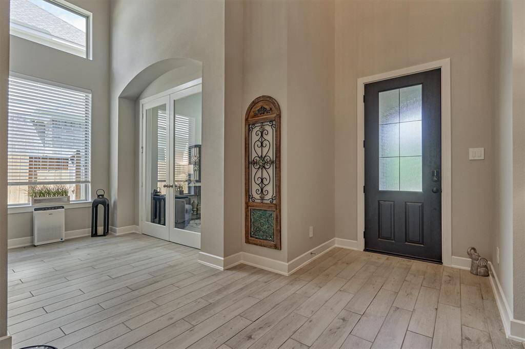 Upon Entering The Home You Will Admire The Finishes And Achitectural Details Inside As Well: Wood-Like Tile And Neutral Colors Run Throughout The First Floor Living Spaces Of This Home. Large Windows Also Fill The Interior With Lots Of Natural Light Throughout The Home.
