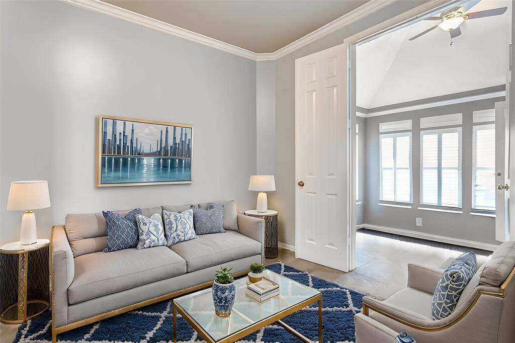 A cozy and adaptable sitting area connects seamlessly to the primary bedroom, offering potential for a nursery, reading nook, or private office space.