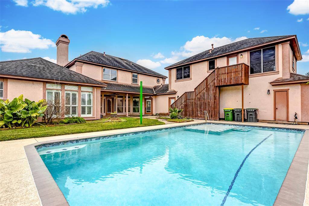 Dive into relaxation in this crystal-clear pool, perfectly complemented by a spacious deck for entertaining. The backyard is a private oasis, complete with lush landscaping and ample space for outdoor fun and leisure.