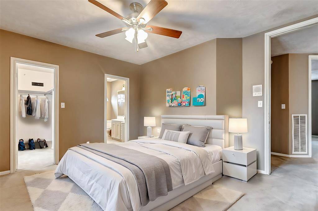 This bedroom offers plenty of space, natural light, and convenient access to an en-suite bath and walk-in closet.