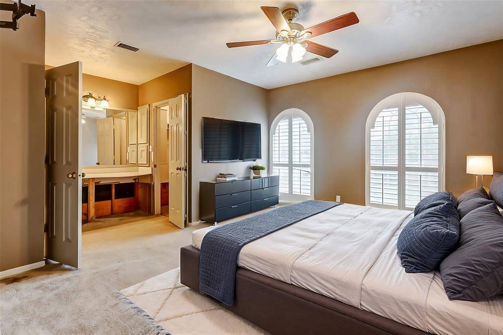 This spacious bedroom is flooded with natural light from the elegant double arched windows, adding character and warmth to the space. The ensuite bathroom, with its convenient vanity area, offers privacy and functionality. Neutral tones make this room a blank canvas for your personal style.