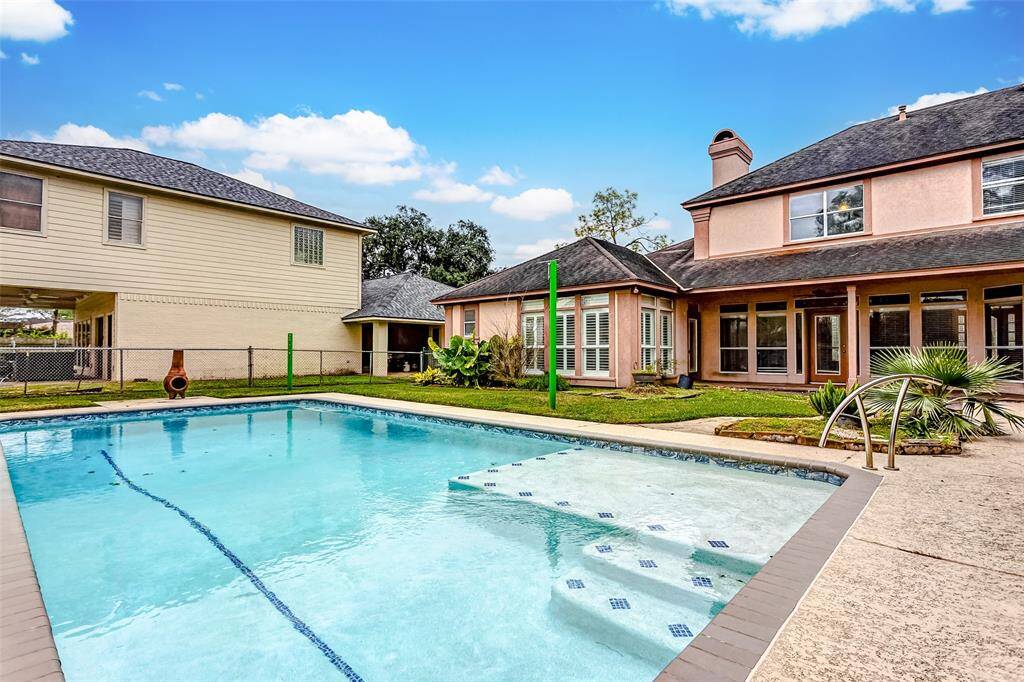 This backyard is an entertainer's dream with its shimmering pool, a shaded patio, and vibrant greenery. Perfect for hosting pool parties or enjoying quiet summer afternoons in your private paradise.
