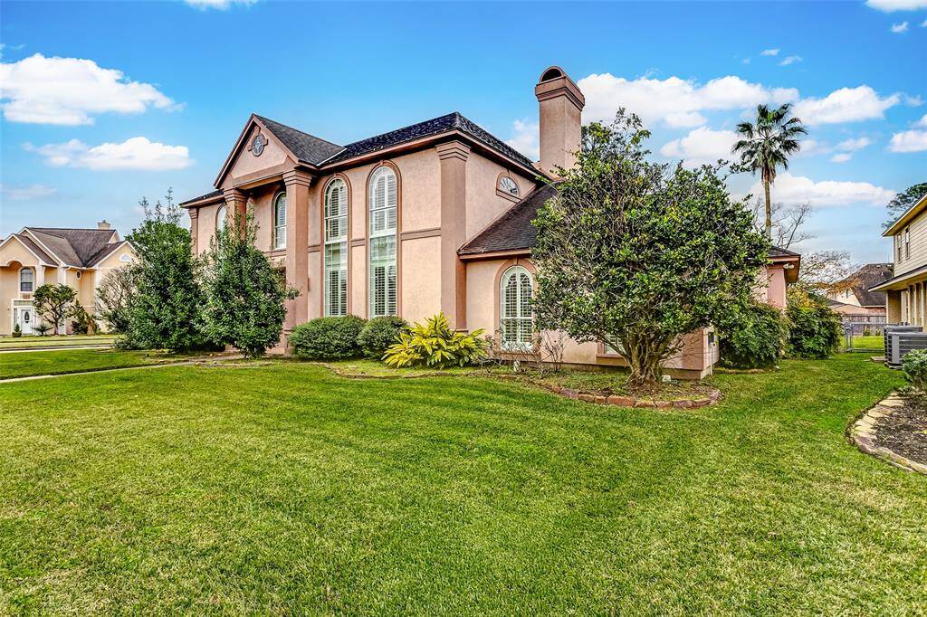 This grand traditional-style home impresses from the first glance with its stately architecture and impeccable landscaping. Nestled on a spacious 13,500 sq. ft. lot, this property offers both curb appeal and privacy with mature greenery framing the entrance.