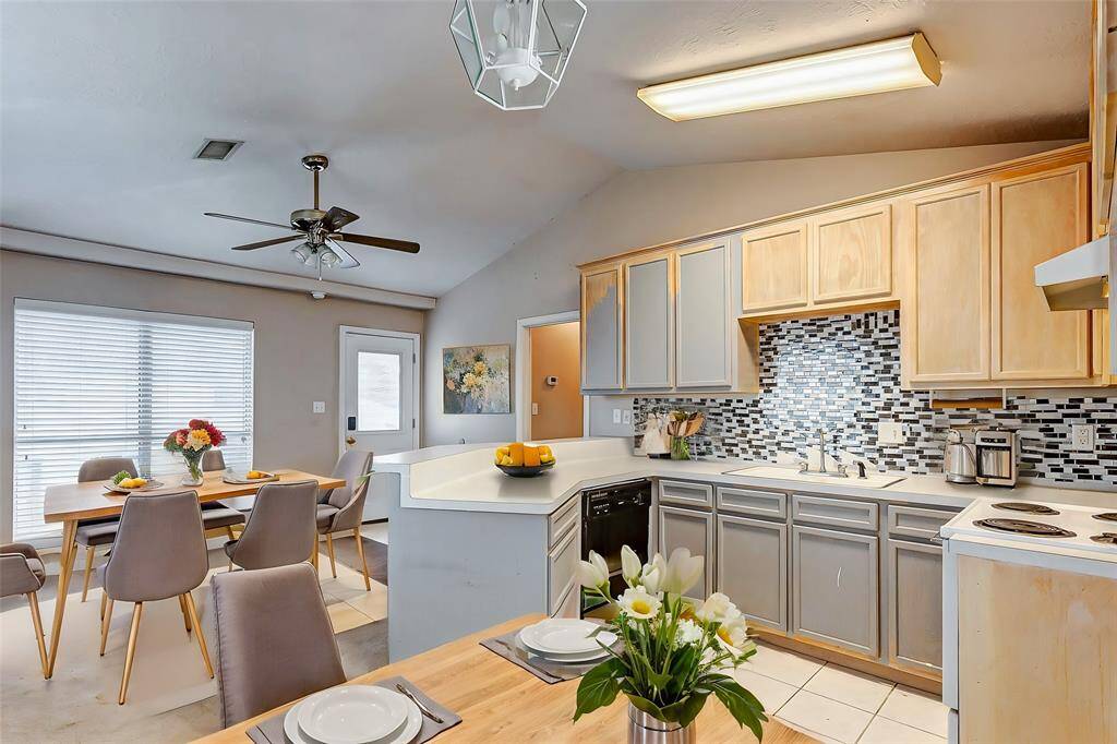 The living area in the garage apartment is cozy and versatile, providing endless possibilities for a guest suite, office, or rental opportunity. Bright windows and vaulted ceilings create an open, airy feel.