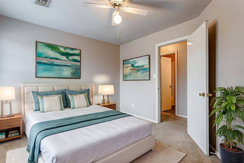 This spacious bedroom features soft natural light and neutral tones, offering a blank canvas for personalization and comfort.